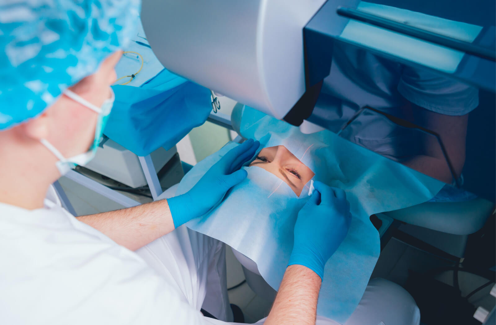 A patient lying in an operating room and a surgeon performing a LASIK surgery.